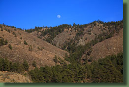 The moon rises over the foothills of Gateway Park