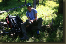 Andra pulls off her boots after a hot stretch of hiking